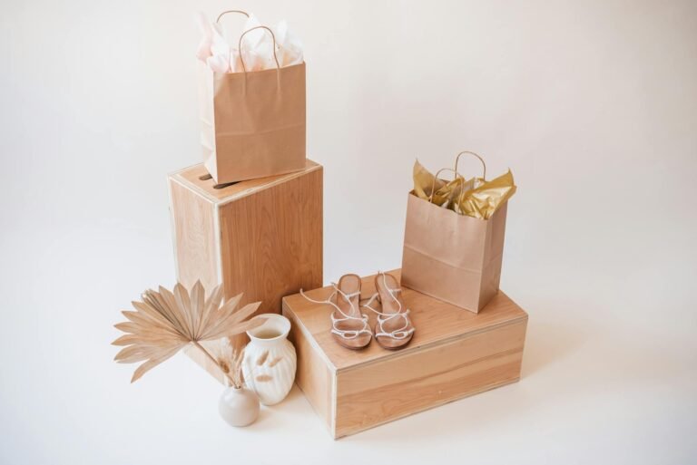 A stylish arrangement of paper bags, wooden boxes, and decorative items for shopping themes.