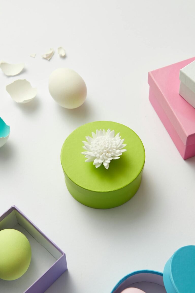 Colorful packaging with an artistic arrangement of flowers and eggshells on a white background.